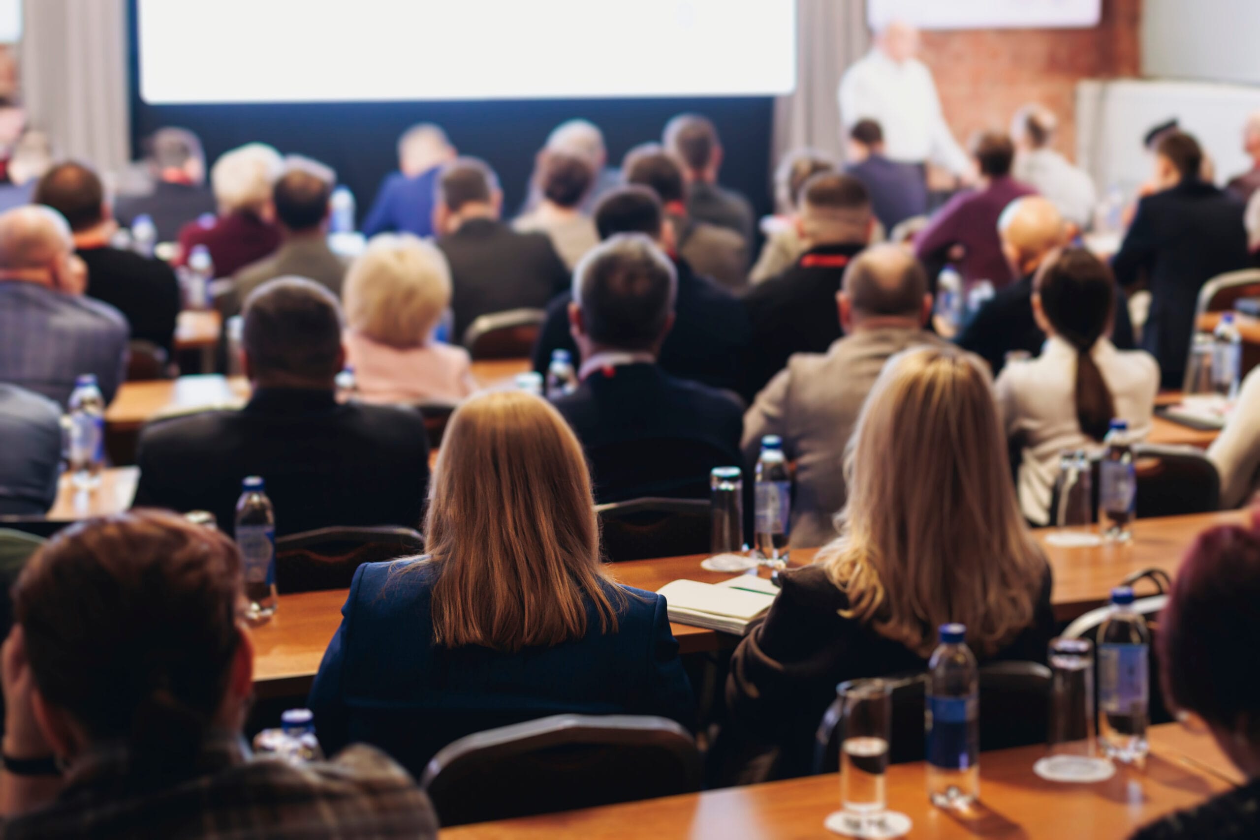 Large audience attending a professional business conference presentation